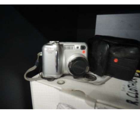 A Nikon Coolpix 4300 digital camera, charger and batteries, memory cards, USB cable and Nikon WC-E63 wide angle converter