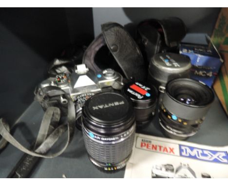 A Pentax MX camera with 50mm lens and Tamron 35-70mm lens, Takumar 135 mm lens and super Paragon 28mm lens