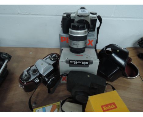 A Pentax MZ30 camera and Pentax 28-80 lens, a Praktica PL Nova 1B, a Kodak 44A camera and flash and filters