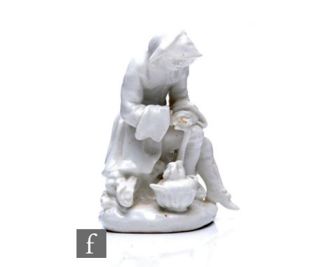 A Bow Porcelain Figure of Winter, circa 1755, from the Rustic Seasons, modelled as a bearded seated figure wearing a hooded c