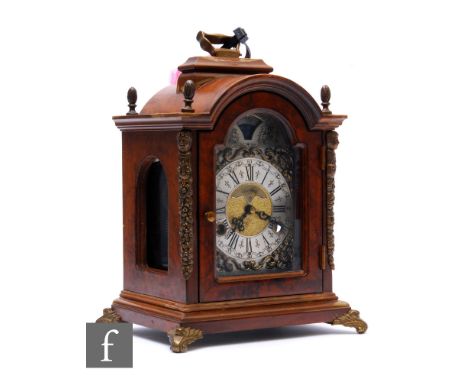 A small 18th Century style walnut cased bracket clock by Wuba, silvered arch dial with moonphase and striking movement, on br