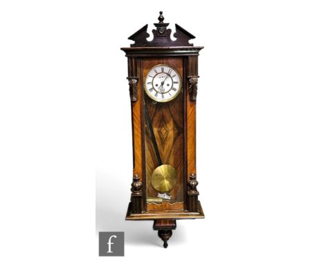 A late 19th Century Austrian walnut cased regulator wall clock, the single weight movement enclosed by a glazed door and flan