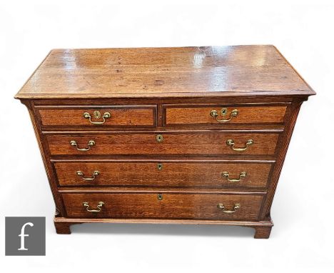 A 19th Century oak and mahogany crossbanded straight front chest of two short and three long drawers, canted sides, brass swa