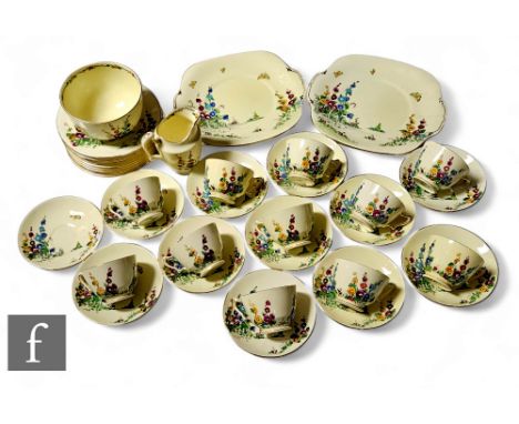 A 1930s Crown Staffordshire part tea service comprising ten cups, saucers and plates, two bread and butter plates and cream a
