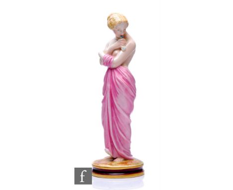 A late 19th Century Royal Worcester figure of 'Joy' modelled as a scantily clad lady with draped robes holding a dove to her 