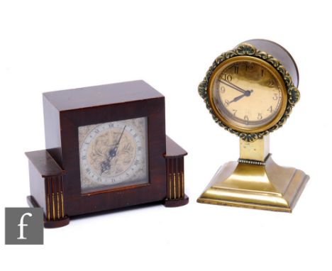 An Edwardian brass mantle clock, the Arabic dial bordered by a floral surround on a shaped pedestal stepped square base, heig