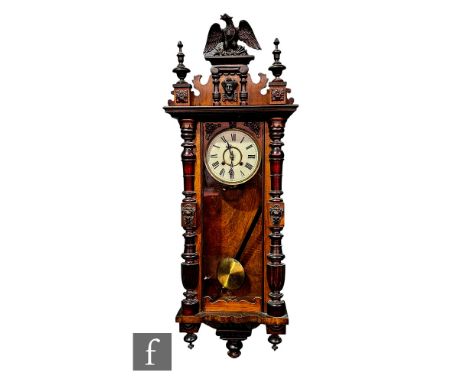 A late 19th Century Vienna regulator wall clock, the eight day spring driven movement enclosed by a glazed pillar door below 