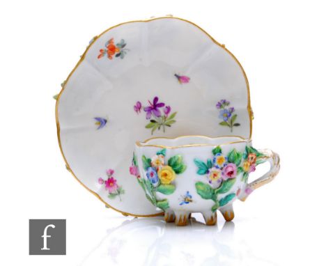 A 19th Century Meissen cabinet cup and saucer, the fluted cup with rustic cross handle and raised to sprue feet, decorated wi