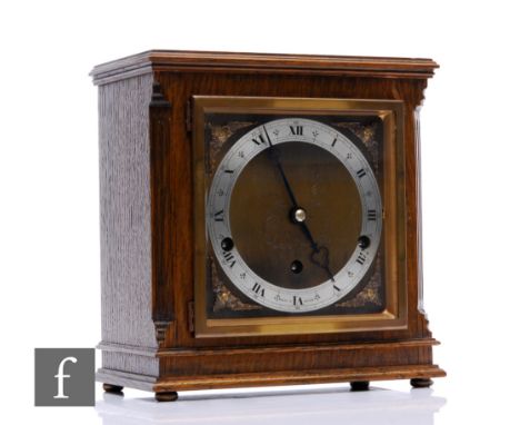 A late 1930s German Elliott oak pillared cased mantle clock with eight day and Westminster and Whittingham chiming movement s