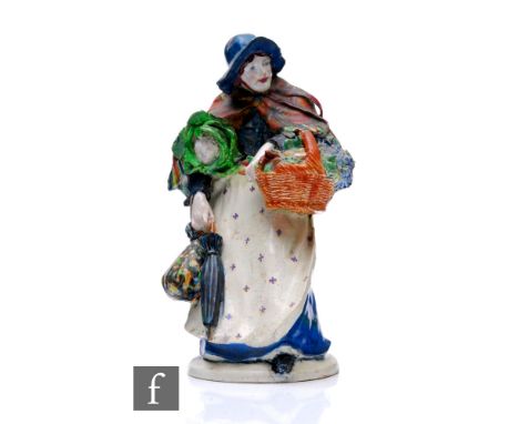 An early 20th Century ceramic figure by Sidney Keats Cope, modelled as a street vendor with bonnet shawl and parasol and carr