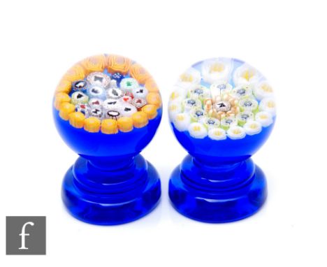 A contemporary Jim Hart glass pedestal weight of spherical form, internally decorated with multiple silhouette canes with an 