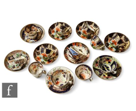 A collection of 19th Century Staffordshire cups and saucers all in variants of the Imari design in a red, blue gold and green