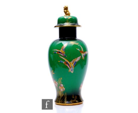 A large 1930s temple jar and cover decorated in the Mallard pattern with birds in flight over a riverside scene with flowers,