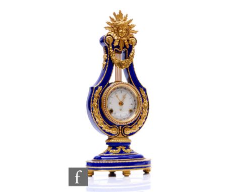 A late 20th Century French Marie-Antoinette gilt metal lute shaped clock, with sunburst mask over a dial on oval base, height