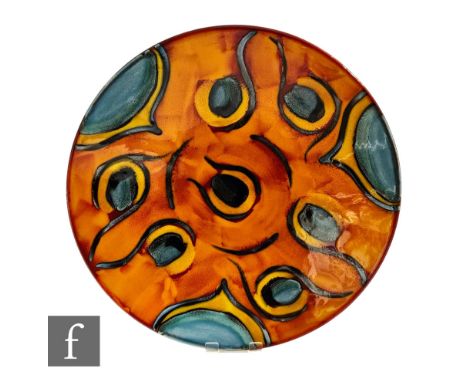 A large later 20th Century Poole Pottery wall plaque or charger of shallow circular form, decorated in the Peacock pattern wi