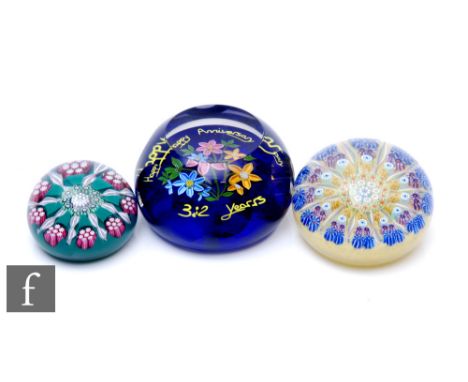 A contemporary Perthshire glass Anniversary paperweight, of domed form with facet cut sides and top, internally decorated to 