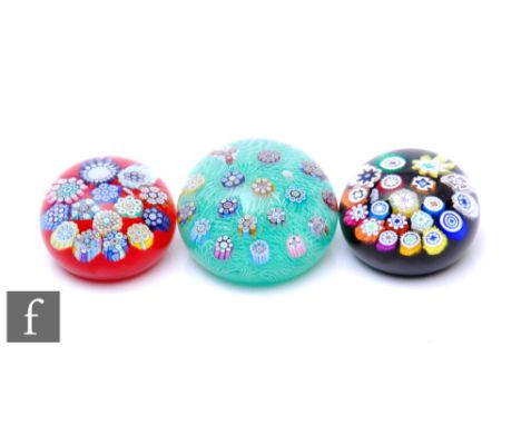 A contemporary Peter McDougall glass paperweight, of domed form, internally decorated with spaced complex millefiori canes al