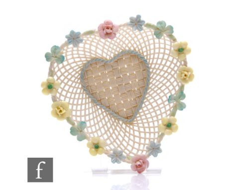 A Belleek heart shaped basket, with ornate flowers to the rim of the basket, applied banner to the base 'BELLEEK R IRELAND' (