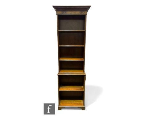 An Edwardian style mahogany bookcase of narrow proportions, dentil fluted cornice over and adjustable shelf interior above a 