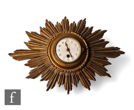 A 1920s French gilt sunburst wall clock, white circular dial, width 46cm. 