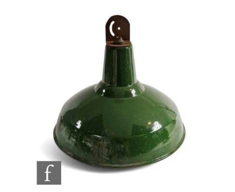 A 20th Century industrial green and white enamelled ceiling light of domed form, height 35cm. 