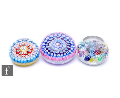 A contemporary Peter McDougall glass paperweight, of domed form with facet cut sides and top, internally decorated with a gro
