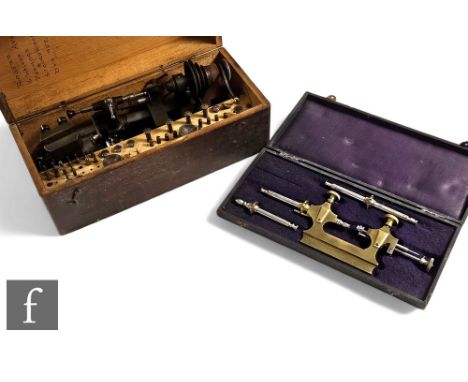 An early 20th Century watch maker's lathe with accessories, cased, and a brass French Jacot tool. (2) 