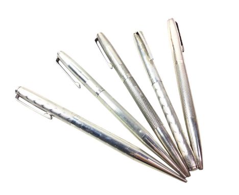 FOUR SILVER CASED PROPELLING PENCILS, and a silver cased roller ball penQty: 5