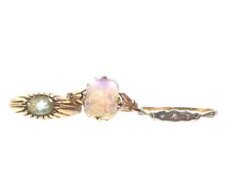 THREE GOLD DRESS RINGS, including one set with diamond chips, another with a blue stone and one with a faux opal, two in nine