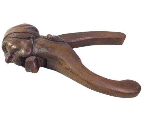 CARVED WOOD NUT CRACKER, possibly Black Forest, carved with a male head20cm long 