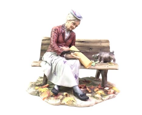 CAPODIMONTE FIGURE, SANDRO MAGGIONI modelled as a lady sat on a bench feeding a dog21cm high 