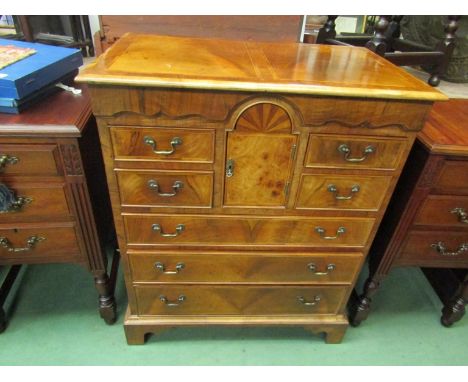 A 17th Century revival walnut chest of four short over three graduating long drawers, central cabinet with sun-ray inlay, sha