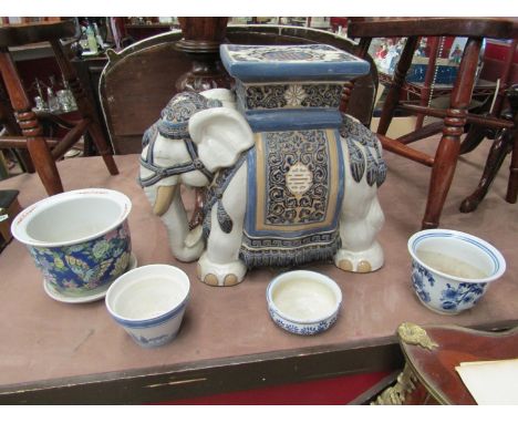 A ceramic elephant jardiniere stand with four plant pot holders