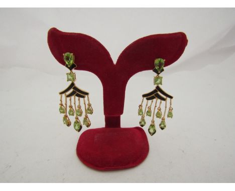 A pair of chandelier earrings, silver gold overlay set with peridot and black enamel detail  