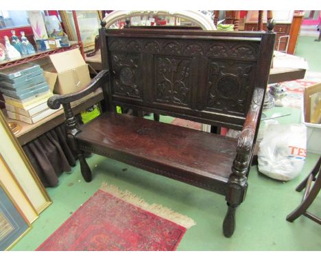 A 17th Century and later carved oak three panel back rest settle the scroll end arms on turned supports