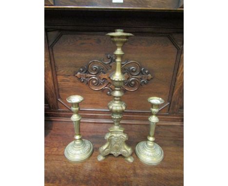 A pair of brass candlesticks and larger table centre candlestick (3), tallest 54cm