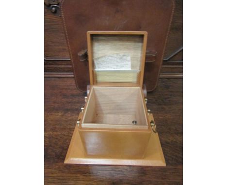 A tan leather covered cigarette box together with a brown leather covered pipe rack