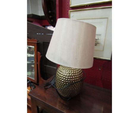 A brass hammered style ceramic table lamp base with shade
