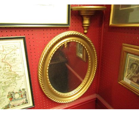 A gilt oval mirror and wall bracket (2), mirror total 47cm high, bracket 18cm high 