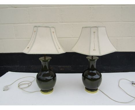 A pair of modern green ceramic lamp bases with pierced Art Nouveau shades, 74cm tall