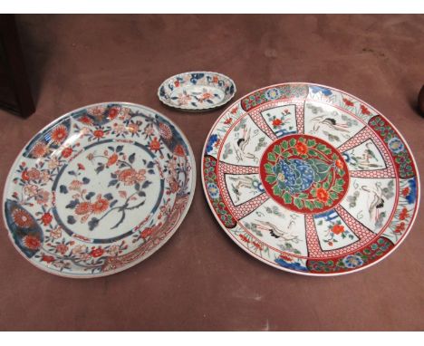 An Imari wall plate (a/f - small chip to rim), matching oval dish together with one other wall plate with cranes and Japanese