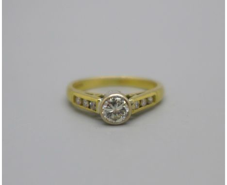 An 18ct gold and diamond ring, approximately 0.25ct centre stone and set with six further diamonds, 3.1g, J 