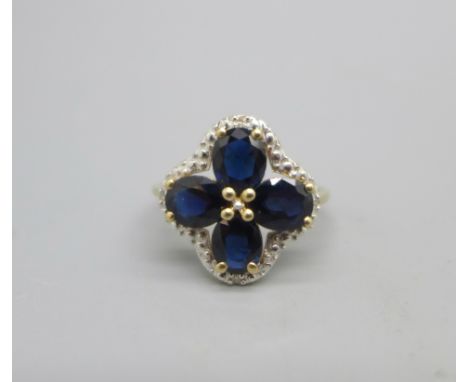 A 9ct gold ring set with blue stones and four small diamonds, 2.4g, O 