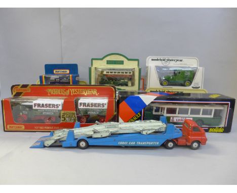 A collection of model vehicles including a Solido bus and a playworn Corgi Transporter 