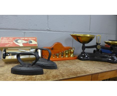 A set of Libra kitchen scales and two graduated sets of seven weights, two flat irons and a shoe stretcher 