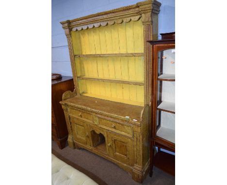 An 18th Century Irish painted dresser with moulded cornice over a two shelf back and a base with two drawers, two doors and a