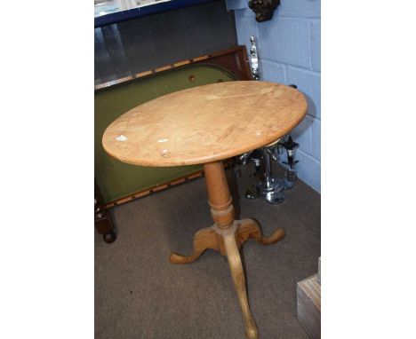 A pine tripod based table with circular top and turned column, top61cm diameter