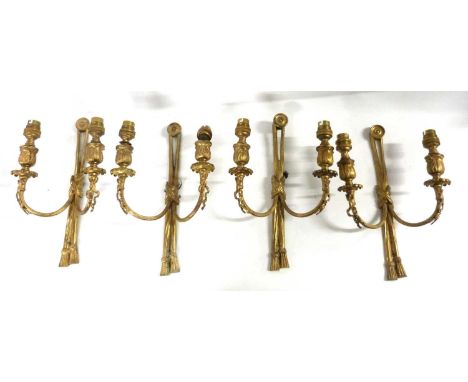 A set of four early 20th Century gilt brass double light wall sconces with tassel decoration, 22cm high