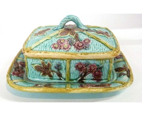 A Maiolica dish and cover, decorated in relief with flowers, 23cm long