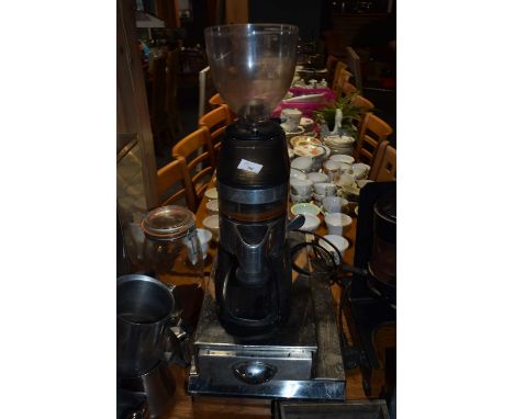 Coffee bean grinder together with two under machine coffee waste trays